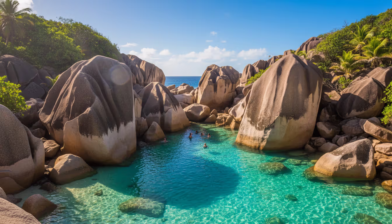 The Baths at Virgin Gorda in the British Virgin Islands with massive granite boulders forming grottoes over turquoise water and people swimming